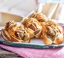 Three cheeseburger hot dogs with sticky sweet & sour onions
