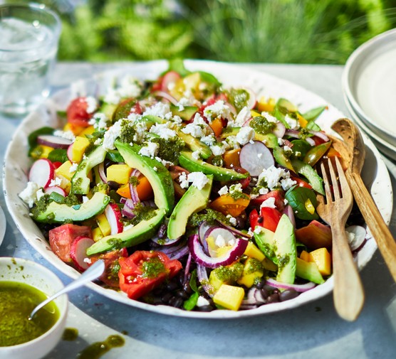 Salad recipes Plate of colourful summer salad topped with halloumi, with cutlery