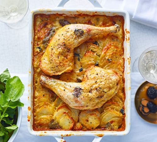Dinner party mains Rectangular dish with two chicken legs and potato gratin